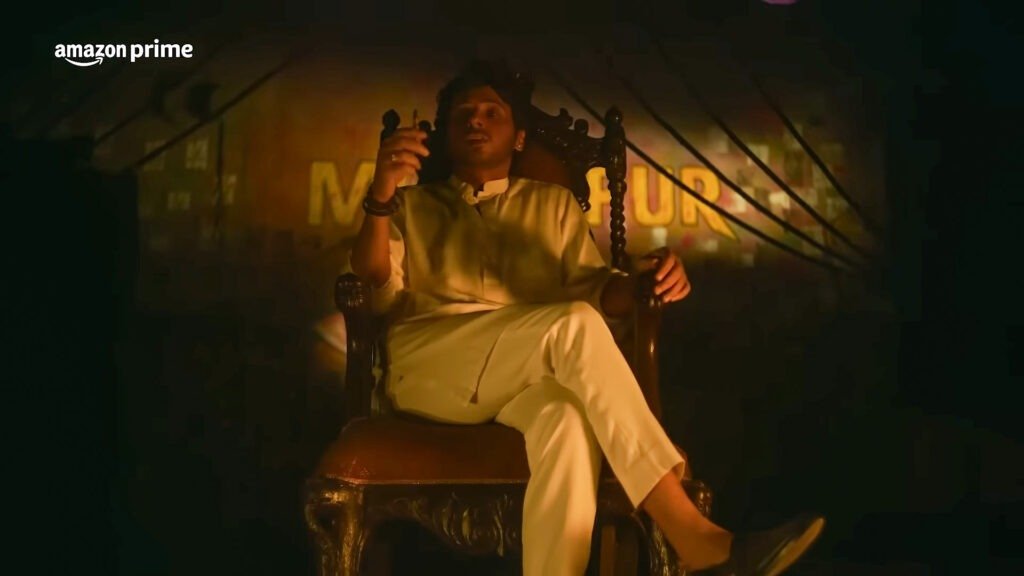 The character Munna Bhaiya from ‘Mirzapur,’ seated on an ornate wooden chair in a dimly lit setting with the series’ logo prominently displayed in the background.