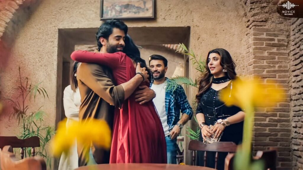 Sheheryar Munawar and Urwa Hocane embracing each other in a warm hug at a social gathering. The intimate atmosphere and their close interaction highlight the romantic connection between them, making it a captivating moment that reflects their on-screen romance.