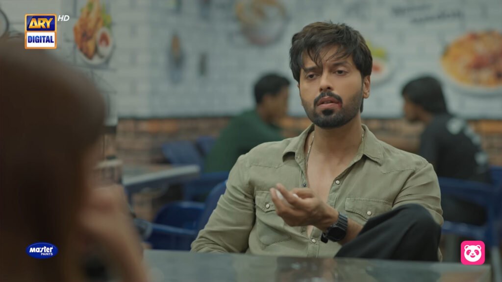 Scene from ‘Kabhi Main Kabhi Tum’ showing Fahad Mustafa, sitting at a restaurant table while looking at Sahrjeena, possibly depicting a moment from the ending of the series. Kabhi Main Kabhi Tum Ending Explained.