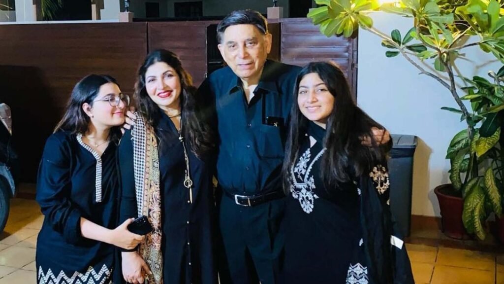 Shagufta Ejaz’s husband and family dressed in formal attire at an outdoor evening event.