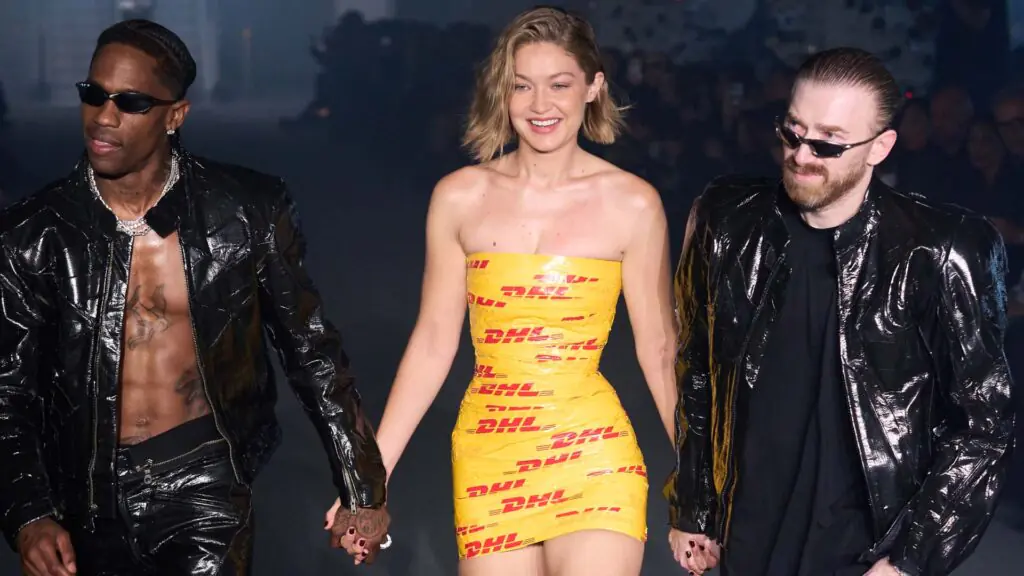 Gigi Hadid in DHL Dress: How This Tape Look Became 2024's Biggest Fashion Buzz 2 Gigi Hadid in DHL Dress walking on runway