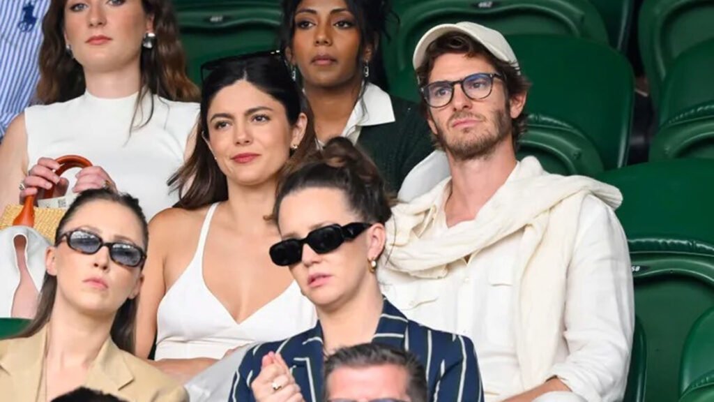 Monica Barbaro and Andrew Garfield smiling at Wimbledon