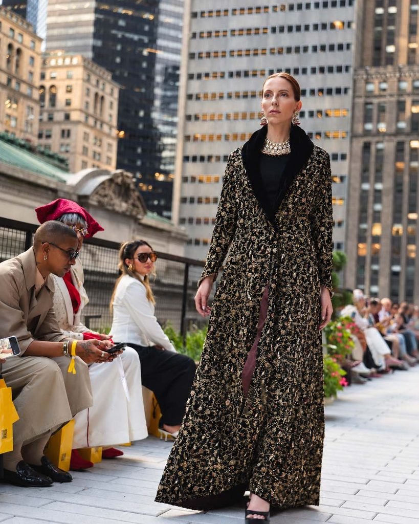 Parishae Adnan Puts Pakistan on the Global Fashion Map 2 A model walks the New York Fashion Week runway wearing Pakistani designer Parishae Adnan upcycled couture creation, โA Pishwas Becomes A Coat,โ from her sustainable circular fashion Second Skin collection featured in Quill Quest Magazine.